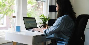 Woman working in home office at her computer.