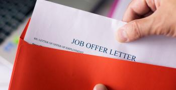 A man's hand pulling out a job offer letter out of a red folder.